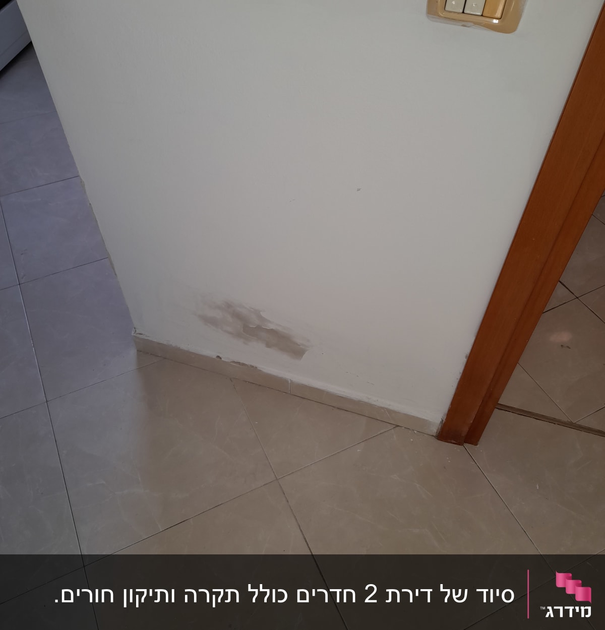 קיר עם כתם צבע מתקלף ליד מתגי חשמל